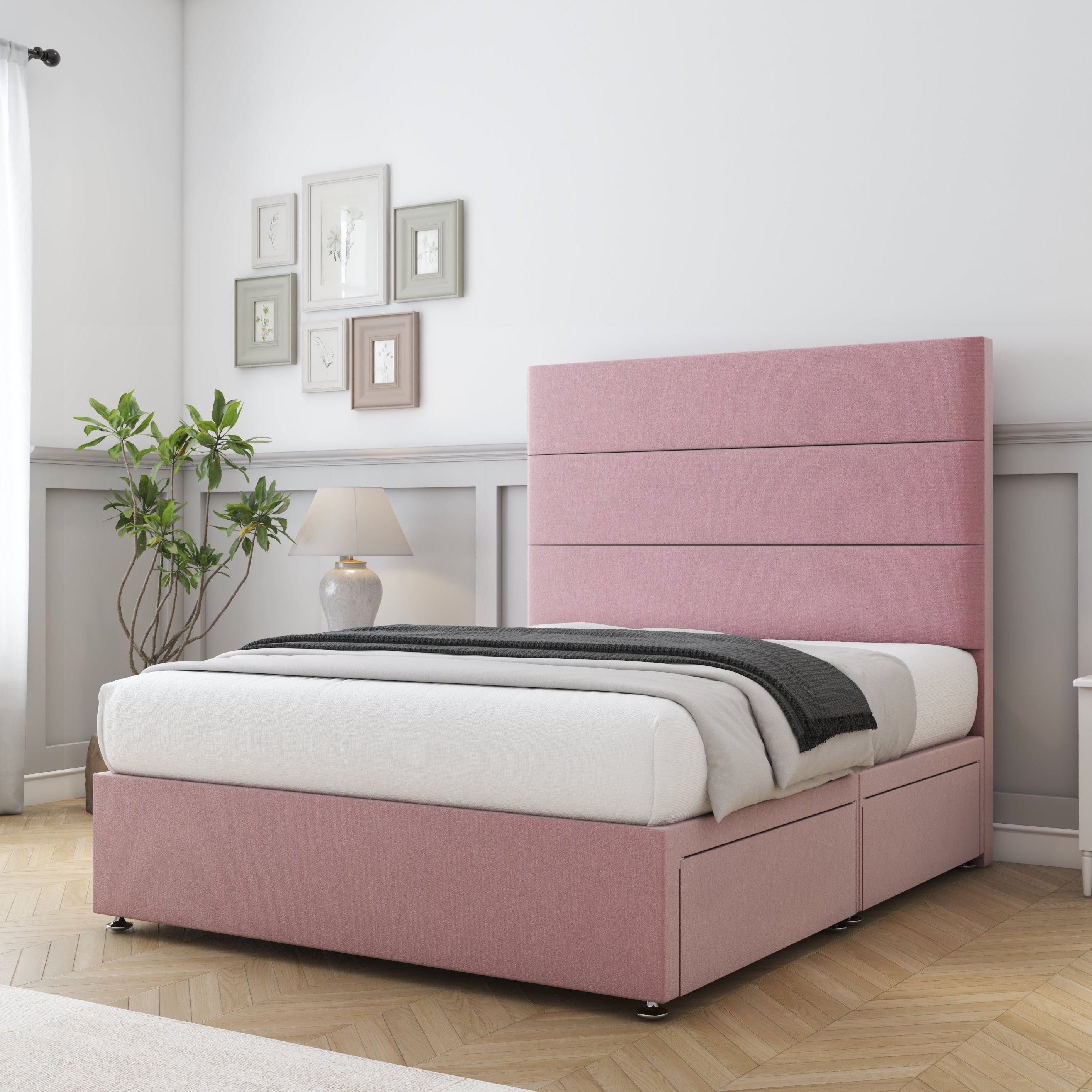Pink bed in a bedroom with white walls and wooden flooring
