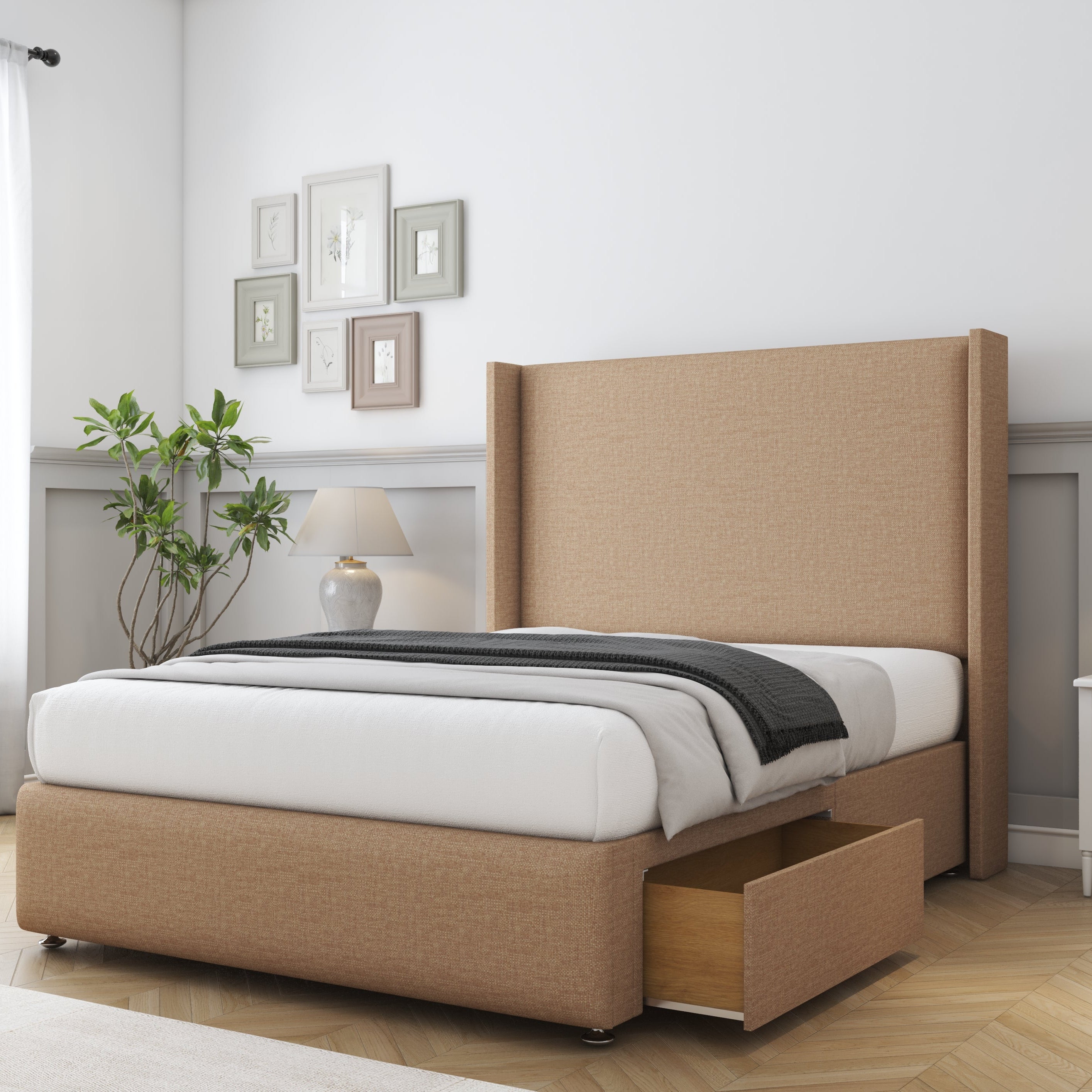 Beige upholstered bed with storage drawers in a bedroom setting.